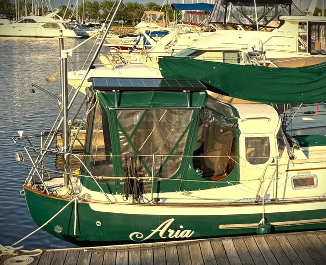 Aria Yacht Photos Pics Pacific Seacraft 37 sailboat, 2000 model, docked with green canopy and solar panels.