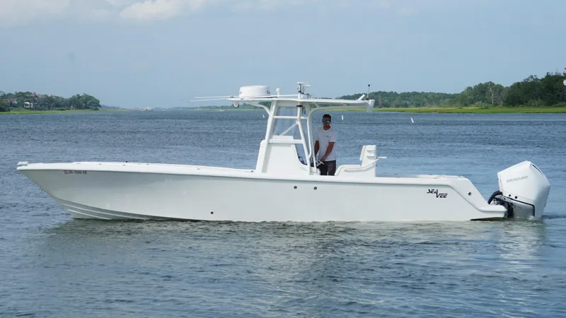  Yacht Photos Pics 2004 SeaVee 310B boat on calm water, featuring a sleek white design.