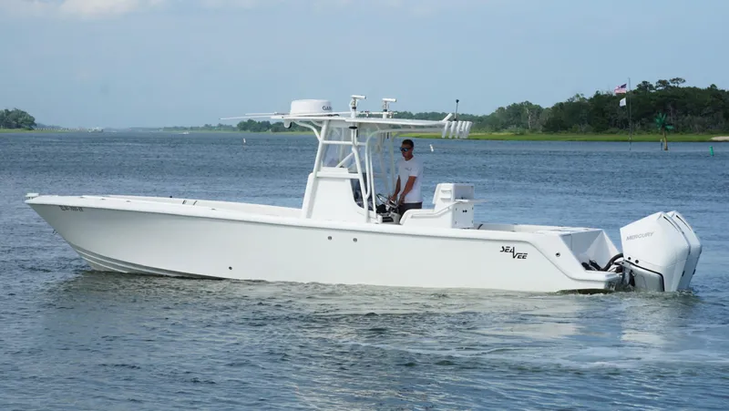  Yacht Photos Pics 2004 SeaVee 310B boat cruising on a calm waterway.