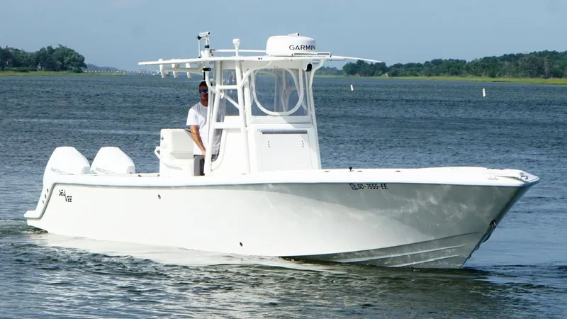  Yacht Photos Pics 2004 SeaVee 310B boat cruising on a calm lake with a clear sky.