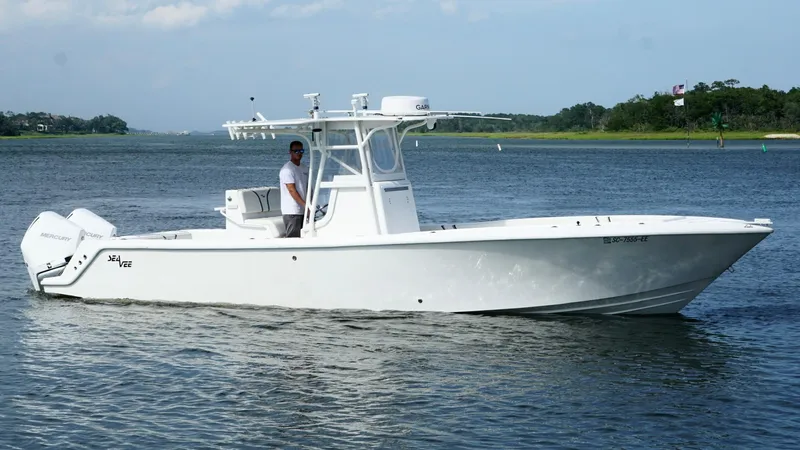  Yacht Photos Pics 2004 SeaVee 310B boat on calm water, featuring a sleek white design.