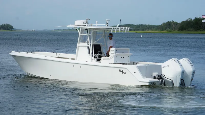  Yacht Photos Pics 2004 SeaVee 310B boat on water, featuring twin outboard engines and a center console.