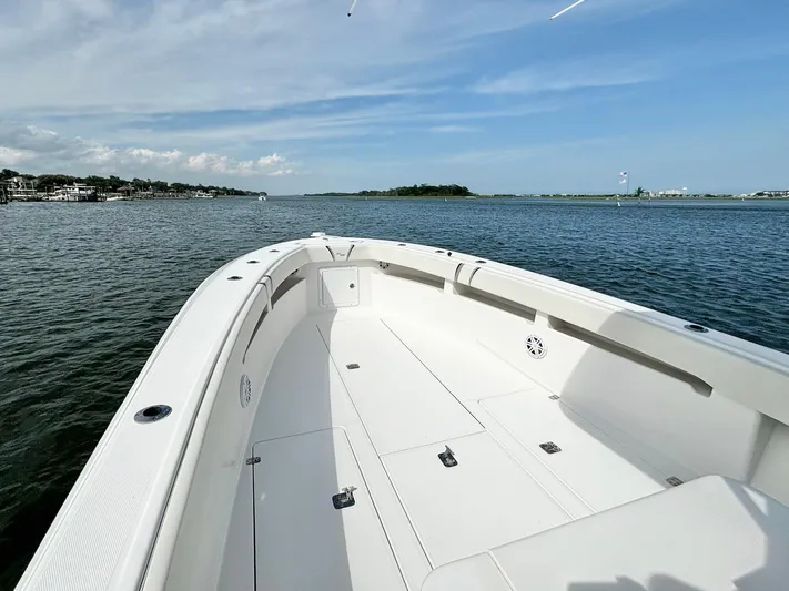  Yacht Photos Pics 2004 SeaVee 310B boat on calm water, clear sky, spacious deck.