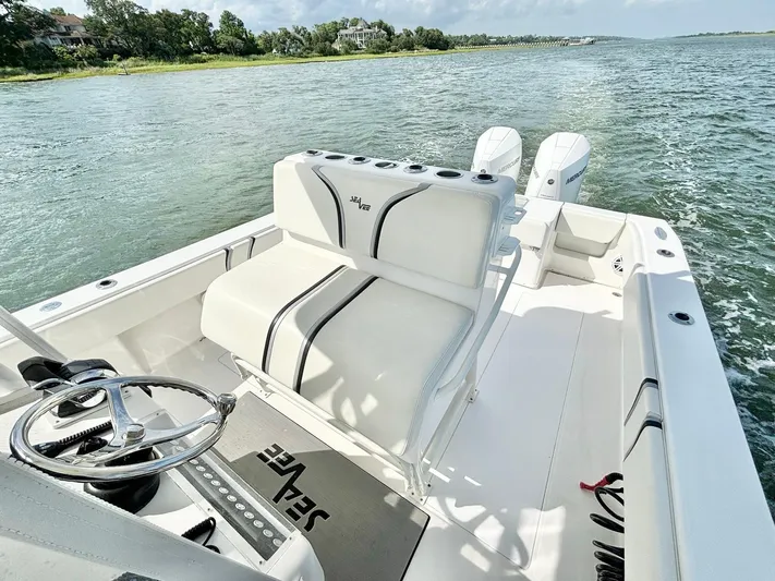  Yacht Photos Pics 2004 SeaVee 310B boat with dual engines cruising on a scenic waterway.