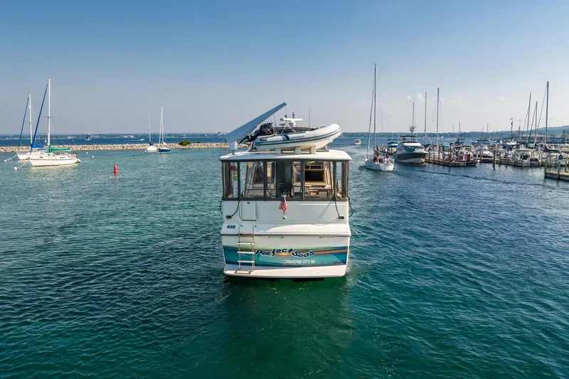 Perfectseas Yacht Photos Pics 1988 Carver 42 Aft Cabin Motoryacht in marina, clear blue water, sunny day.