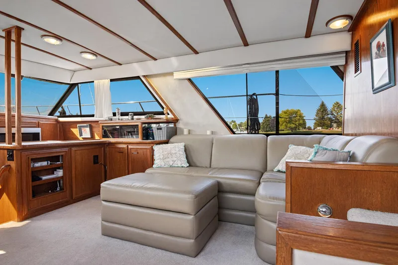 Perfectseas Yacht Photos Pics Luxurious interior of 1988 Carver 42 Aft Cabin Motoryacht with plush seating and wood accents.