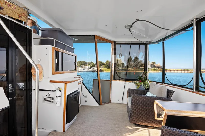 Perfectseas Yacht Photos Pics 1988 Carver 42 Aft Cabin Motoryacht interior with scenic marina view.