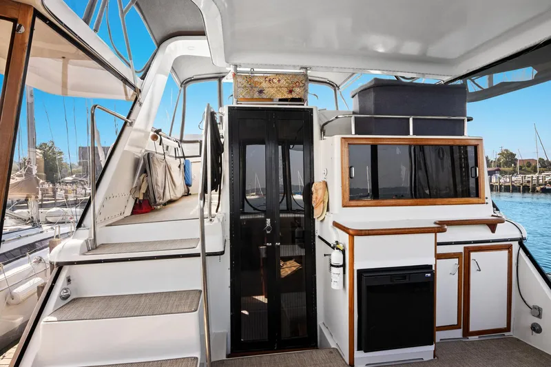 Perfectseas Yacht Photos Pics 1988 Carver 42 Aft Cabin Motoryacht interior with stairs, cabinets, and marina view.