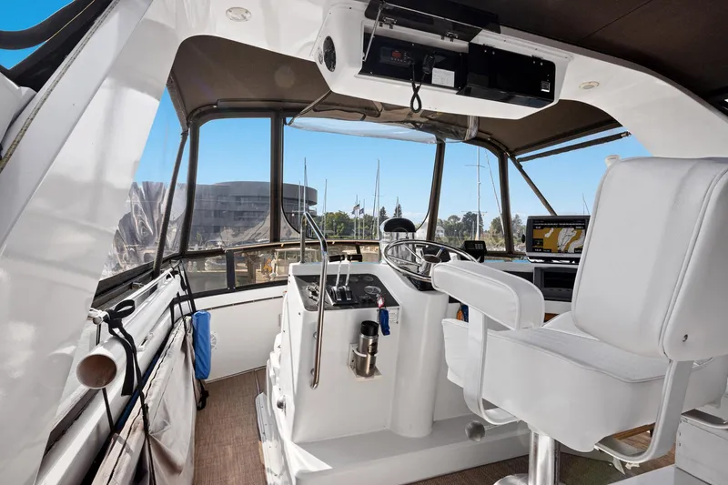 Perfectseas Yacht Photos Pics 1988 Carver 42 Aft Cabin Motoryacht helm with steering wheel and navigation equipment.