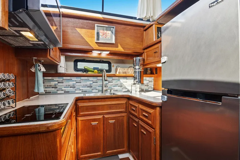 Perfectseas Yacht Photos Pics Luxurious kitchen in 1988 Carver 42 Aft Cabin Motoryacht with modern appliances and wood cabinetry.