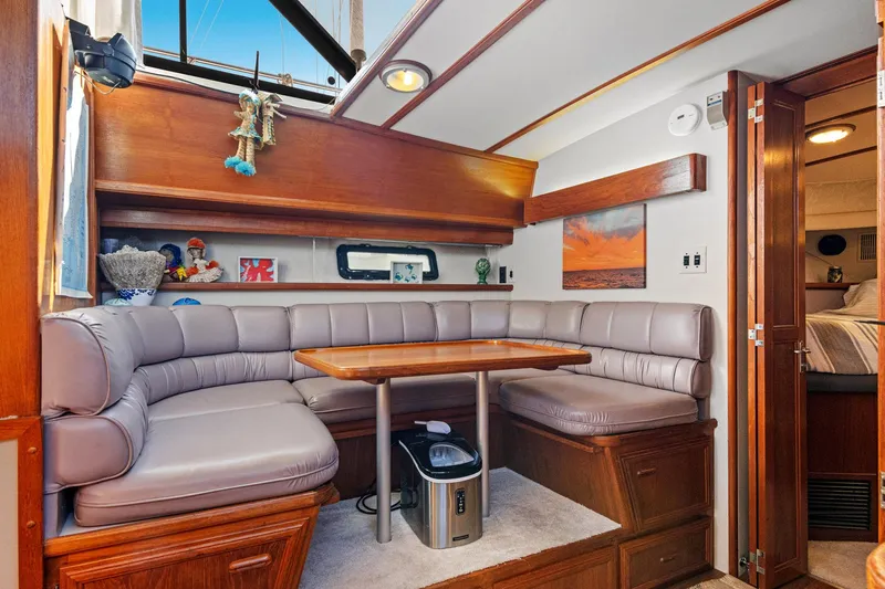 Perfectseas Yacht Photos Pics 1988 Carver 42 Aft Cabin Motoryacht interior with cozy seating and wooden accents.