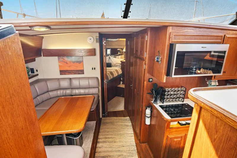 Perfectseas Yacht Photos Pics 1988 Carver 42 Aft Cabin Motoryacht interior with kitchen and dining area.