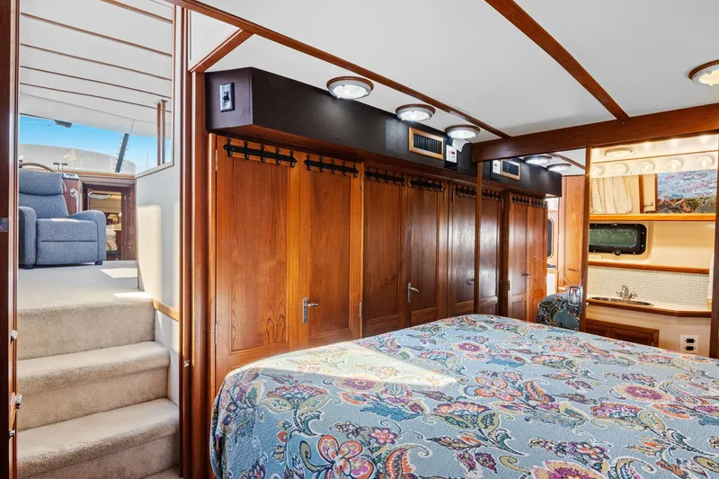Perfectseas Yacht Photos Pics Luxurious interior of 1988 Carver 42 Aft Cabin Motoryacht with wood paneling and patterned bedding.