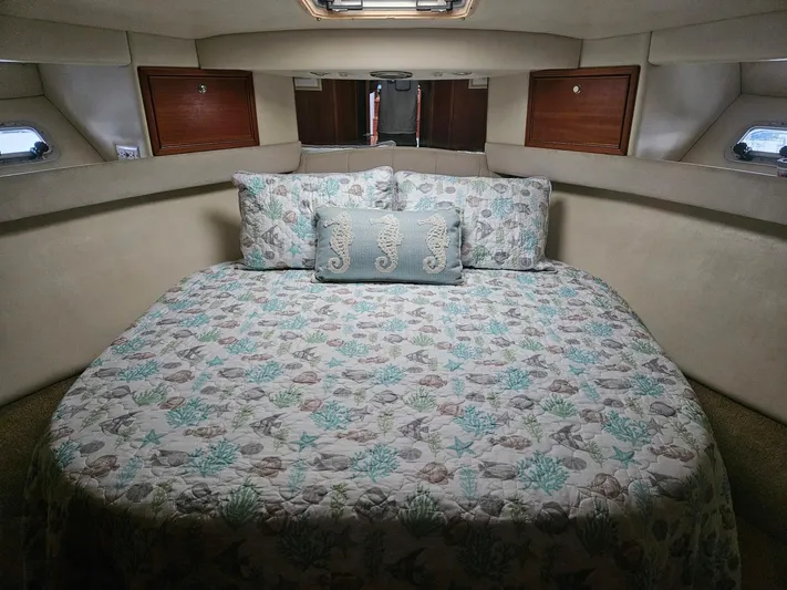  Yacht Photos Pics Cozy bedroom in 1999 Riviera 40AC yacht with nautical-themed bedding.