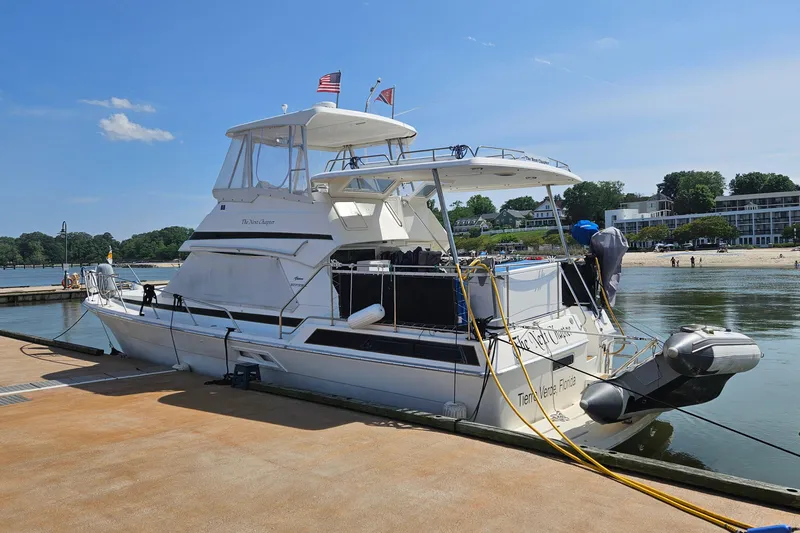  Yacht Photos Pics 1999 Riviera 40AC yacht docked at marina with clear blue sky.