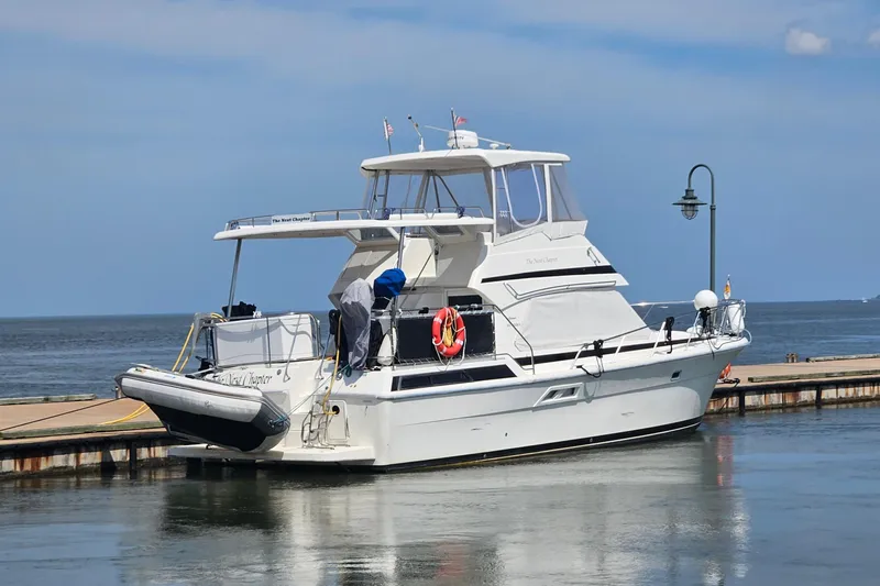  Yacht Photos Pics 1999 Riviera 40AC yacht docked at a marina under a clear blue sky.