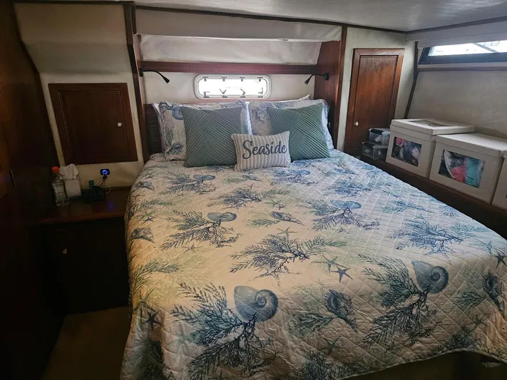  Yacht Photos Pics Cozy bedroom in 1999 Riviera 40AC yacht with nautical-themed bedding.