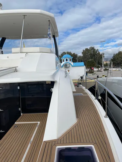  Yacht Photos Pics 2020 Leopard 43 Powercat yacht docked, featuring sleek design and spacious deck under a cloudy sky.