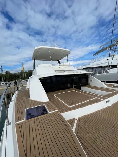  Yacht Photos Pics 2020 Leopard 43 Powercat yacht with spacious deck under a partly cloudy sky.
