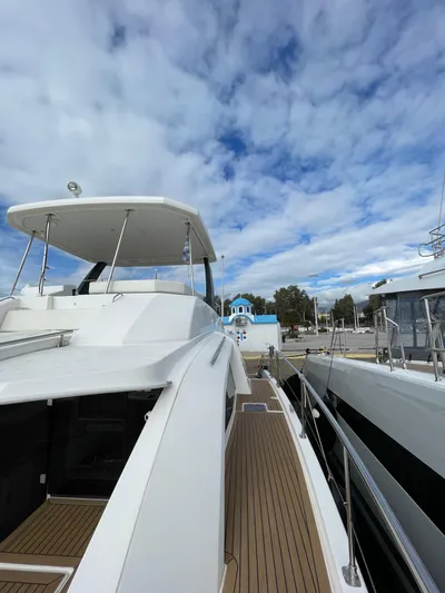 Yacht Photos Pics 2020 Leopard 43 Powercat yacht docked under a partly cloudy sky.
