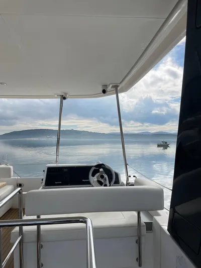  Yacht Photos Pics 2020 Leopard 43 Powercat helm with serene ocean view and distant hills.