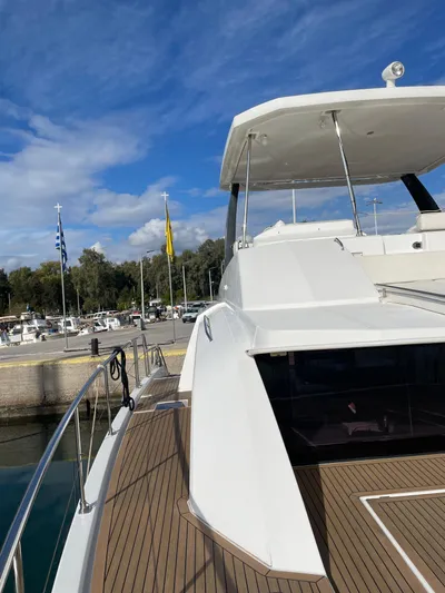  Yacht Photos Pics 2020 Leopard 43 Powercat yacht docked at marina under blue sky.