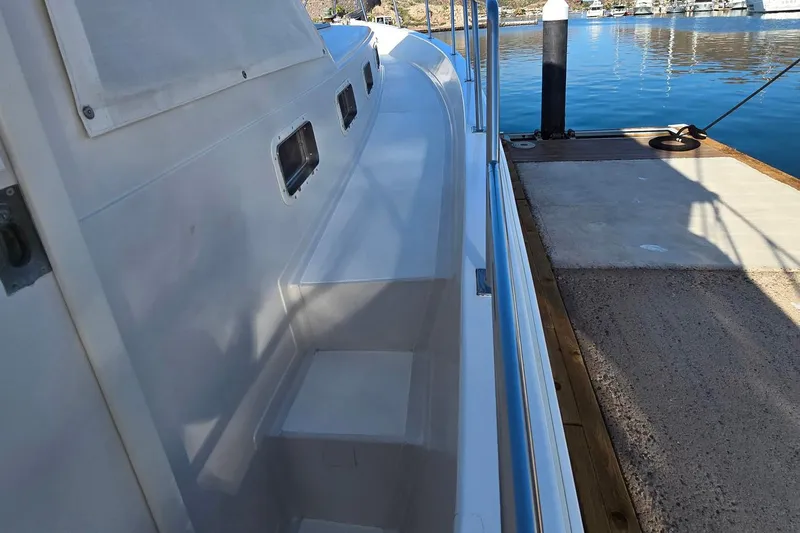 The Wetbar Yacht Photos Pics 1989 Offshore Yachts 48 Sedan docked, showing side deck and railing.