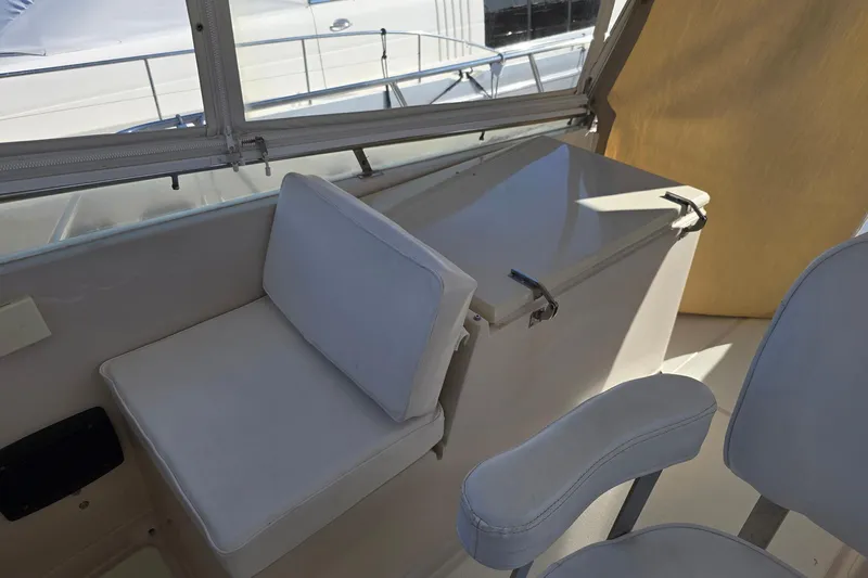 The Wetbar Yacht Photos Pics Interior seating area of 1989 Offshore Yachts 48 Sedan with cushioned seats.