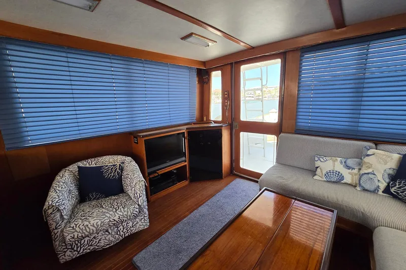 The Wetbar Yacht Photos Pics Interior of 1989 Offshore Yachts 48 Sedan with cozy seating and nautical decor.