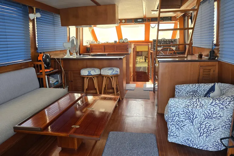 The Wetbar Yacht Photos Pics 1989 Offshore Yachts 48 Sedan interior with wooden furnishings and blue accents.