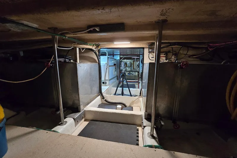 The Wetbar Yacht Photos Pics Engine room of a 1989 Offshore Yachts 48 Sedan, showcasing mechanical components and storage.