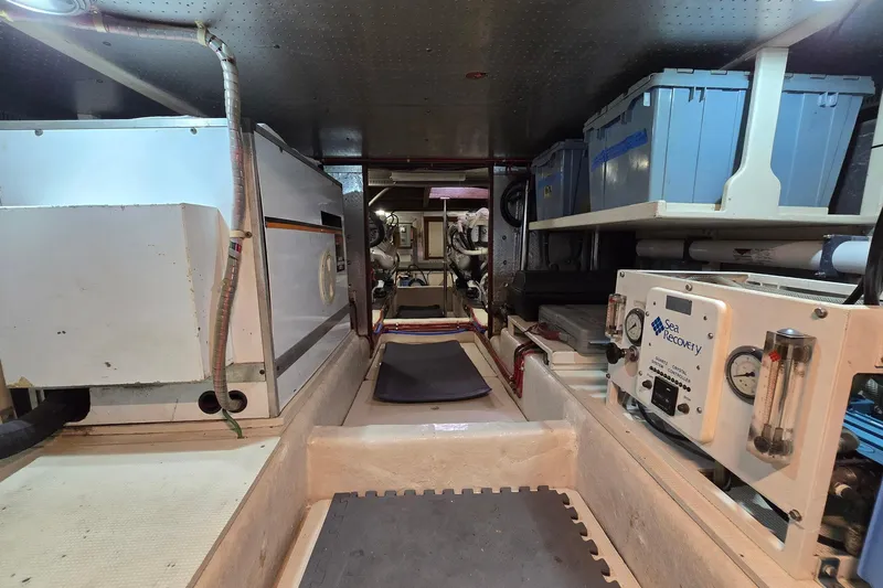 The Wetbar Yacht Photos Pics Engine room of 1989 Offshore Yachts 48 Sedan with equipment and storage boxes.