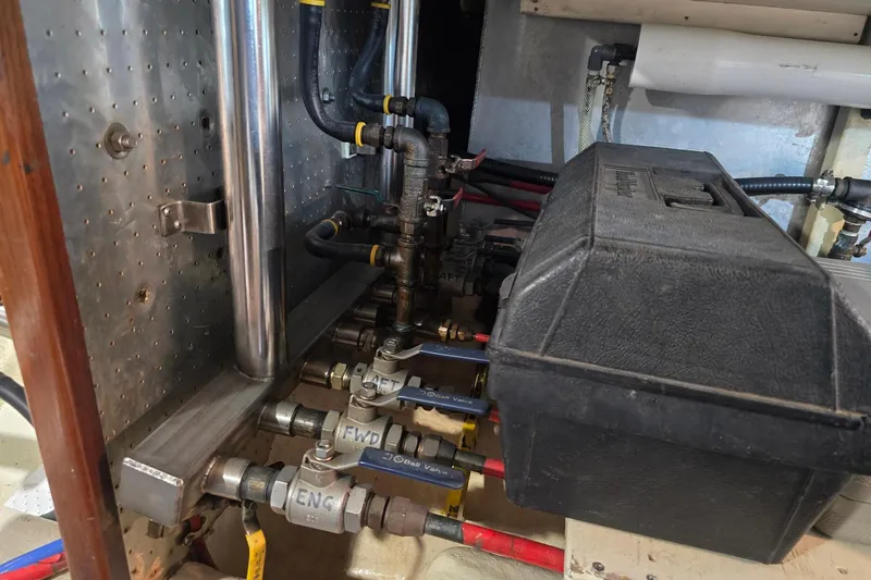 The Wetbar Yacht Photos Pics Engine room of 1989 Offshore Yachts 48 Sedan with visible piping and valves.