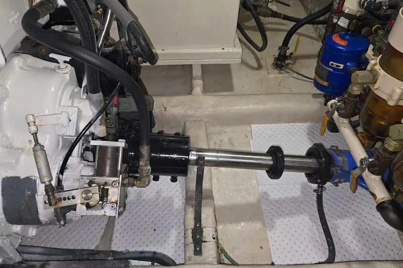 The Wetbar Yacht Photos Pics Engine room of 1989 Offshore Yachts 48 Sedan, showcasing mechanical components and piping.