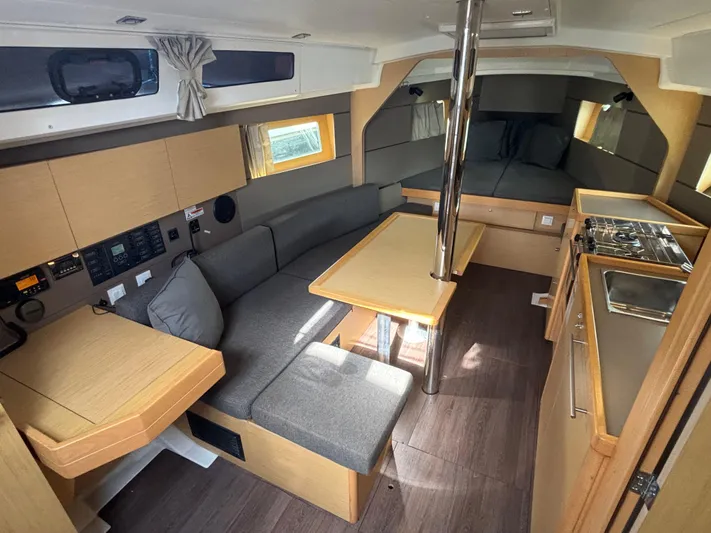 Rio Babe Yacht Photos Pics 2015 Beneteau Oceanis 35 interior with modern kitchen, dining area, and cozy seating.