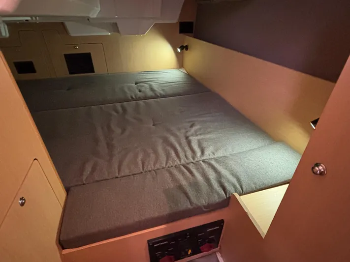 Rio Babe Yacht Photos Pics Cozy cabin interior of 2015 Beneteau Oceanis 35 sailboat with cushioned bed.
