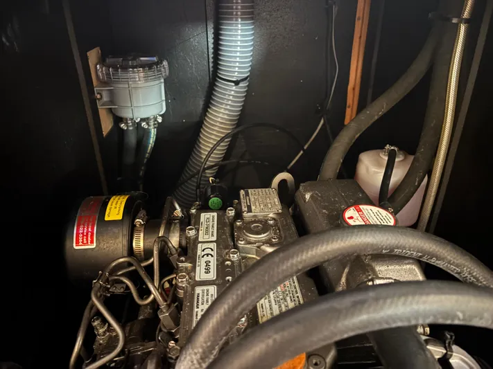 Rio Babe Yacht Photos Pics Engine compartment of a 2015 Beneteau Oceanis 35 sailboat, showing mechanical components and hoses.