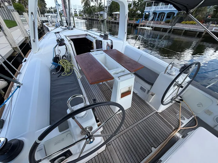 Rio Babe Yacht Photos Pics 2015 Beneteau Oceanis 35 sailboat cockpit with dual steering wheels and wooden table.