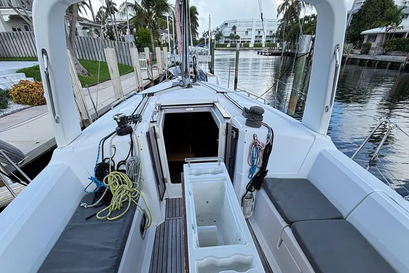 Rio Babe Yacht Photos Pics 2015 Beneteau Oceanis 35 sailboat cockpit with seating, ropes, and open cabin entrance.