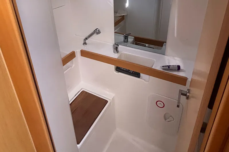 Rio Babe Yacht Photos Pics Compact bathroom in a 2015 Beneteau Oceanis 35 sailboat, featuring a sink and mirror.