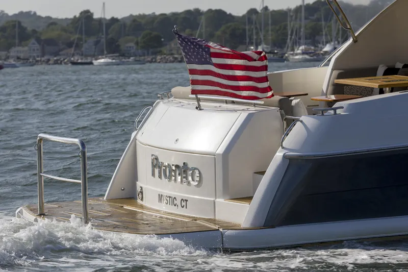 Pronto Yacht Photos Pics 2016 Riviera 5000 Sport Yacht with American flag, cruising near Mystic, CT.