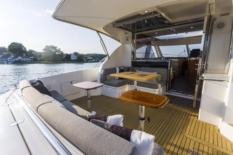 Pronto Yacht Photos Pics Luxurious 2016 Riviera 5000 Sport Yacht with spacious outdoor seating and scenic water view.