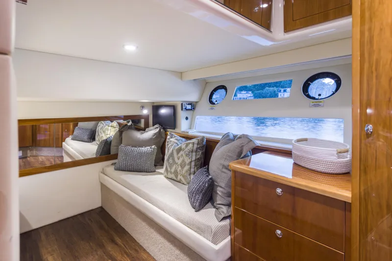 Pronto Yacht Photos Pics Luxurious interior of 2016 Riviera 5000 Sport Yacht with elegant seating and wooden cabinetry.