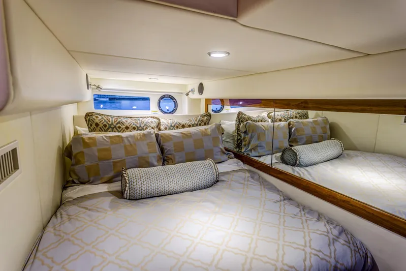Pronto Yacht Photos Pics Luxurious bedroom interior of 2016 Riviera 5000 Sport Yacht with elegant bedding and mirrored wall.