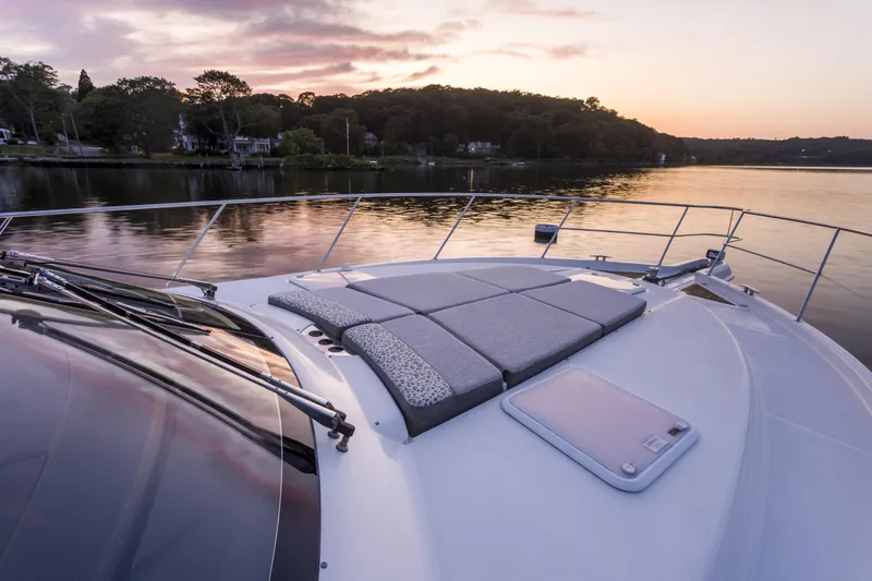 Pronto Yacht Photos Pics 2016 Riviera 5000 Sport Yacht at sunset on tranquil water.