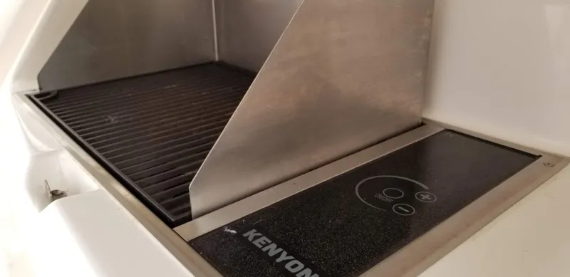 Pronto Yacht Photos Pics Kenyon grill on 2016 Riviera 5000 Sport Yacht, featuring sleek stainless steel design.