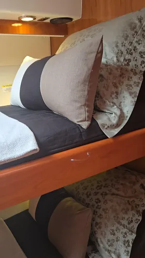 Pronto Yacht Photos Pics Interior of 2016 Riviera 5000 Sport Yacht with cozy bedding and pillows.