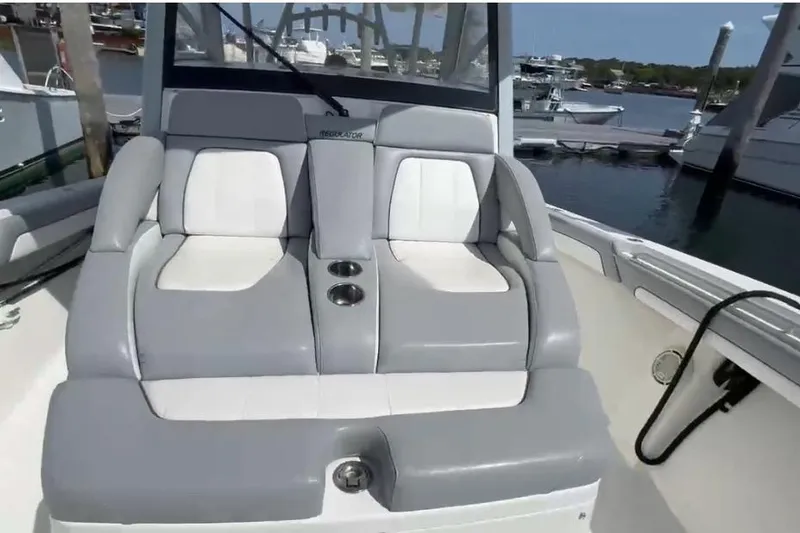 No Name Yacht Photos Pics 2019 Regulator 41 boat with comfortable gray and white seating at a marina.