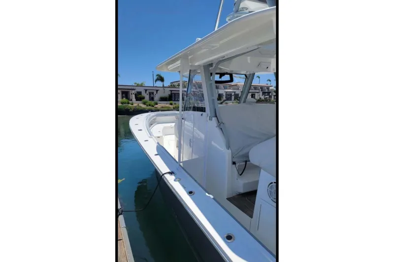 No Name Yacht Photos Pics 2019 Regulator 41 boat docked, showcasing sleek design and spacious deck.