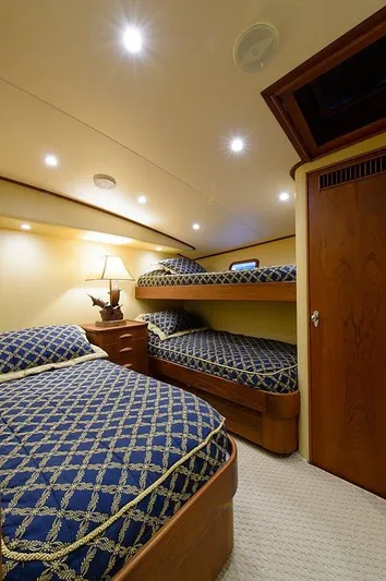 Ship's Cafe Yacht Photos Pics Luxurious cabin on 1987 Custom Carolina Merritt boat with elegant beds and lighting.